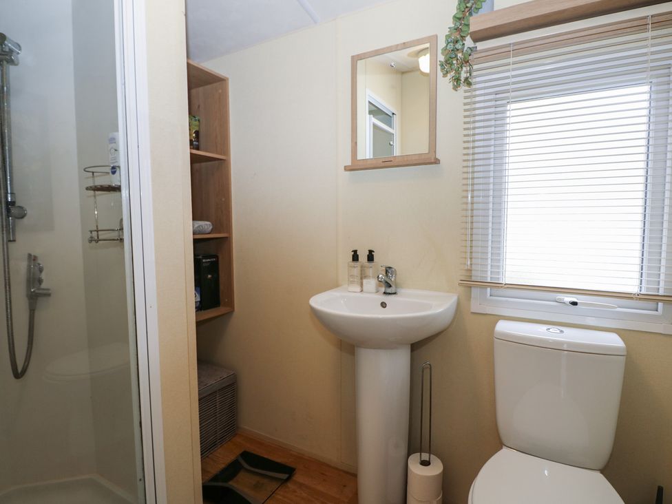 A bathroom with a shower, sink, and toilet at 90 Solent Breezes in Southampton