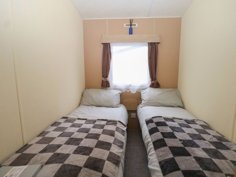 A bedroom with two beds and a window at 90 Solent Breezes in Southampton