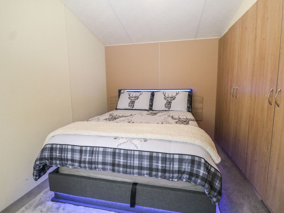 A bedroom with a bed and wardrobe at 90 Solent Breezes Southampton