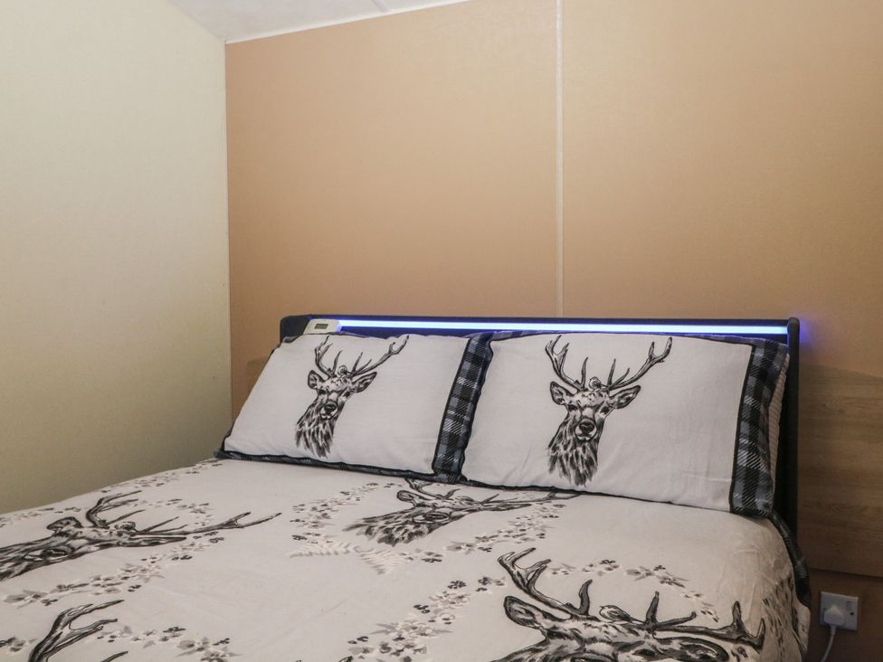 A bedroom with a bed and pillows at 90 Solent Breezes Southampton