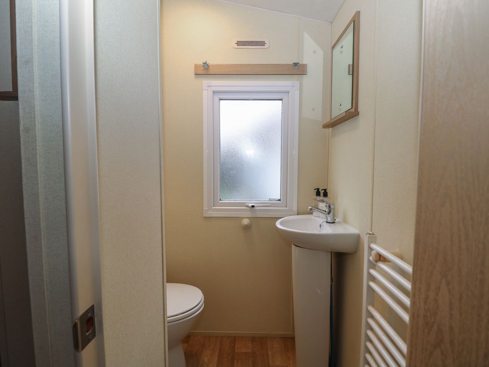 A bathroom with a sink and toilet at 90 Solent Breezes Southampton