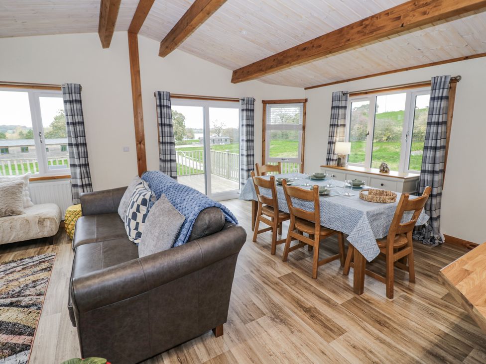 A dining room with a table and chairs at Willow Lodge Admaston near Abbots Bromley