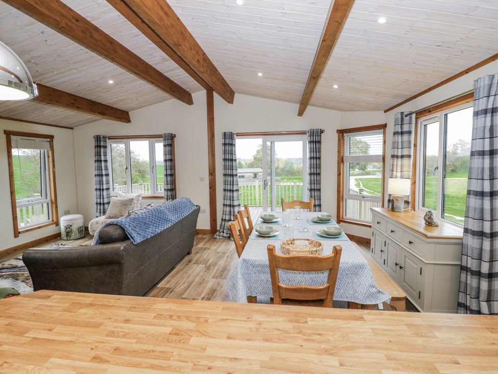 A dining room with a table and chairs at Willow Lodge in Admaston near Abbots Bromley