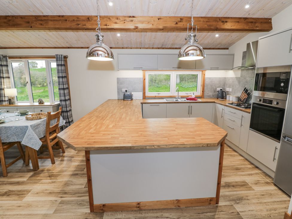 A kitchen with wooden countertop and table at Willow Lodge in Admaston near Abbots Bromley