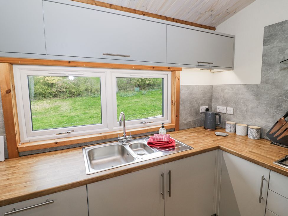 A kitchen with a sink and cabinets at Willow Lodge Admaston near Abbots Bromley