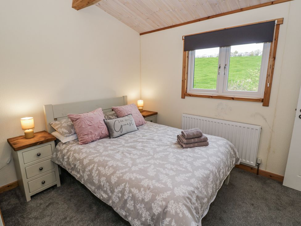 A bedroom with a double bed and nightstands at Willow Lodge in Admaston near Abbots Bromley