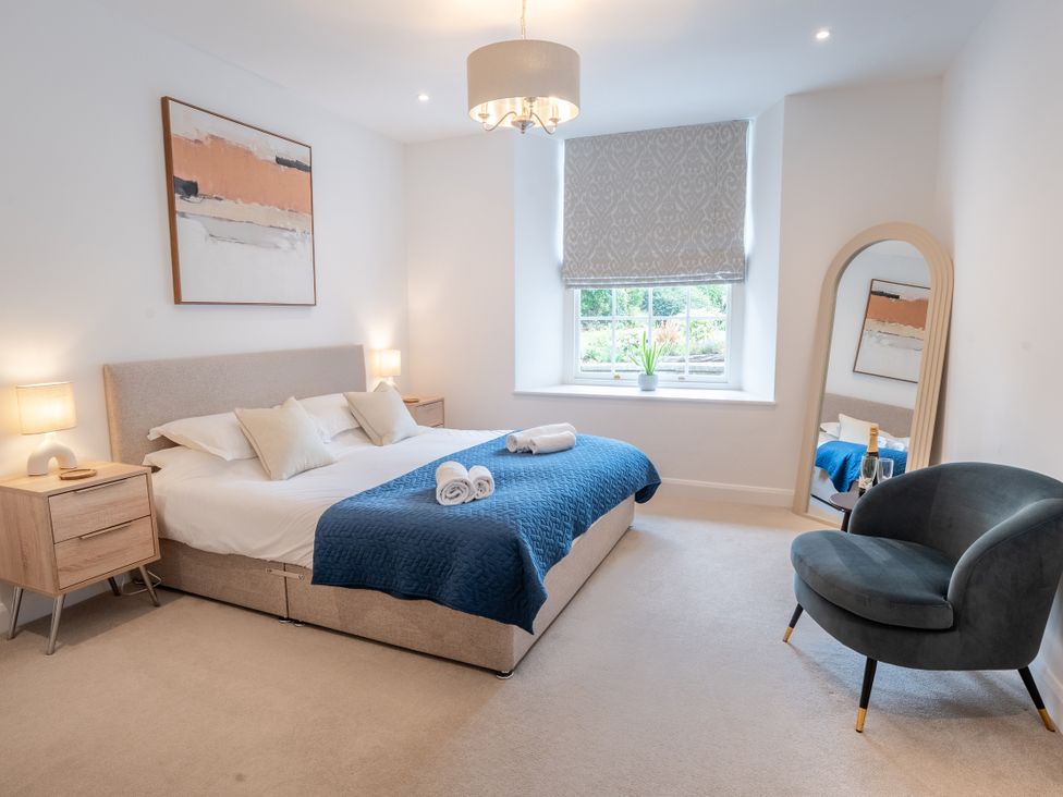 A bedroom with a bed and a window at Derwent in Ulverston