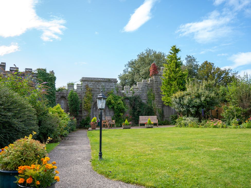 A garden with a pathway and benches at Derwent in Ulverston