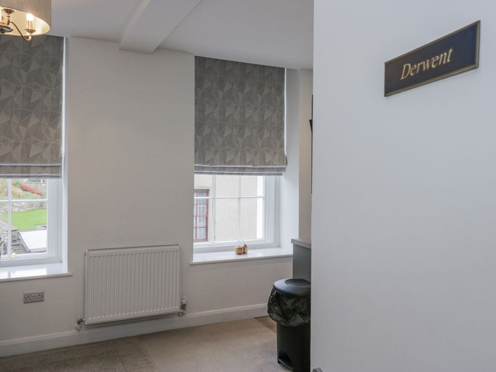 An indoor space with windows and a sign at Derwent in Ulverston
