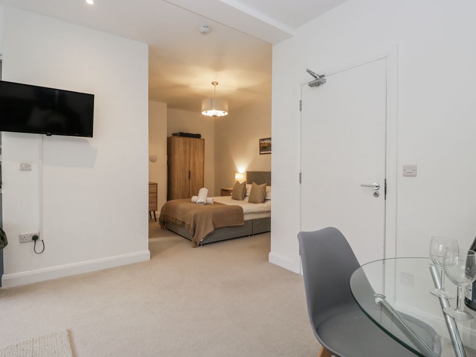 A bedroom with a television and bed at Derwent Ulverston