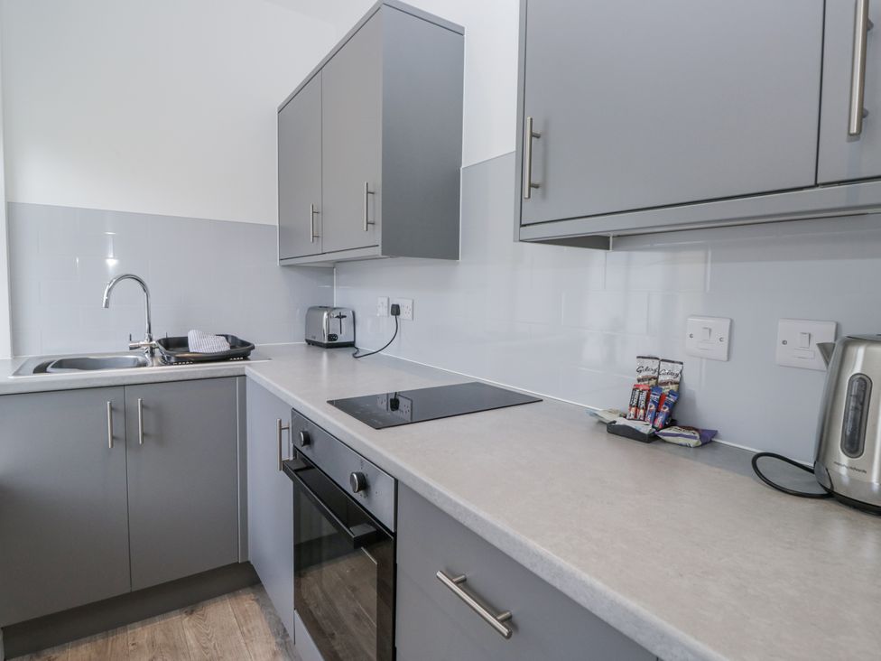 A kitchen with a sink and kitchen cabinets at Derwent in Ulverston