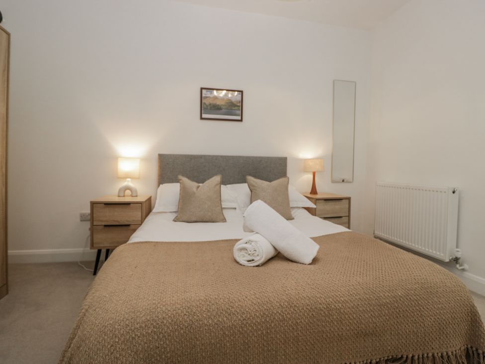 A bedroom with a double bed and bedside tables at Derwent in Ulverston