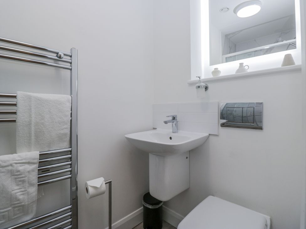 A bathroom with a sink, toilet and towel rail at Derwent in Ulverston