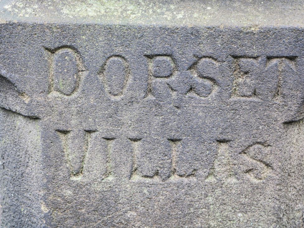 A stone sign with the words DORSET VILLAS at Dorset Villas in Matlock