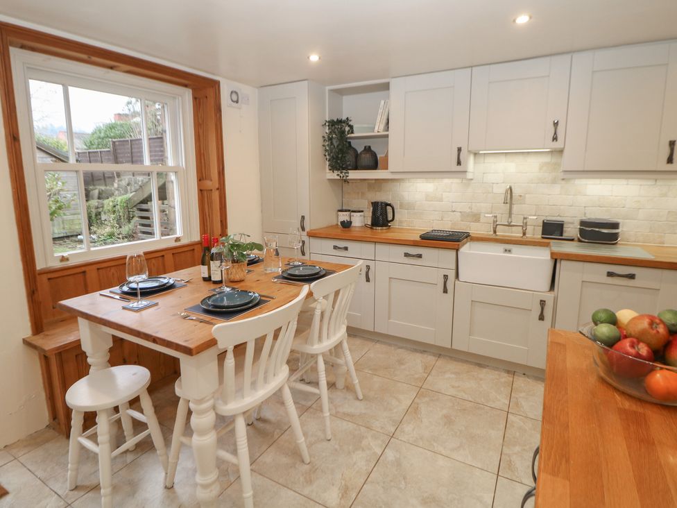 A kitchen with a table and chairs at Dorset Villas in Matlock