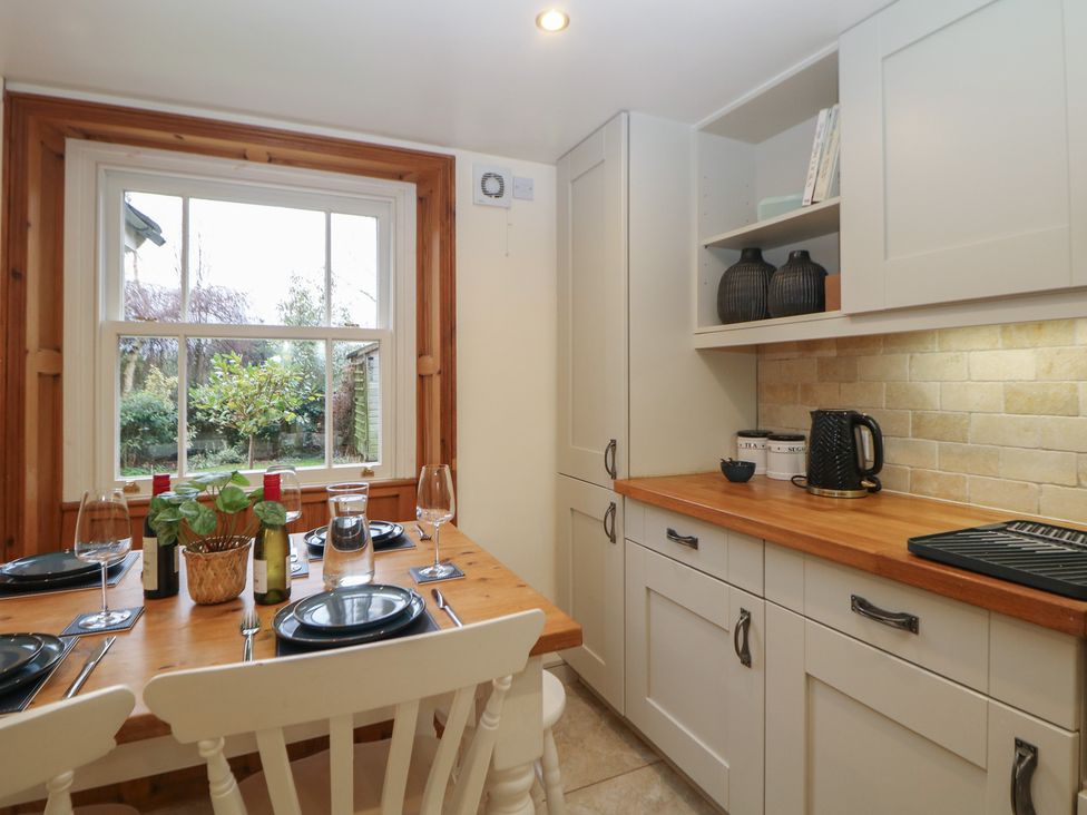 A kitchen with a dining table and plants at Dorset Villas in Matlock