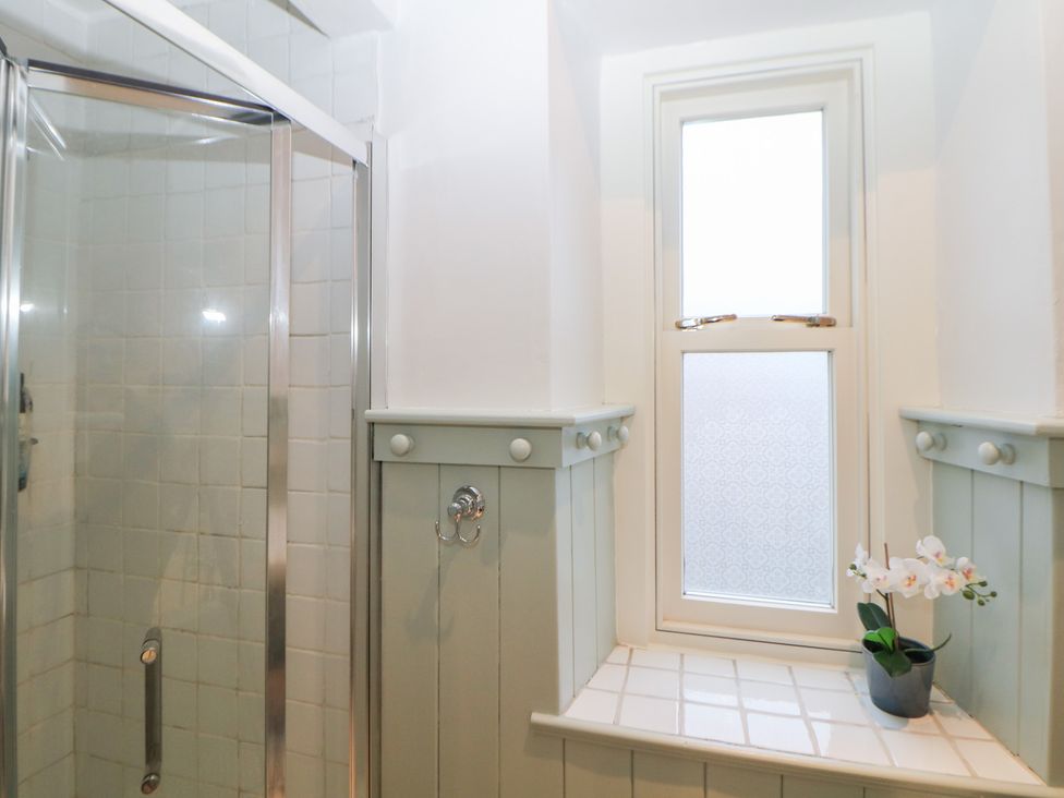 A bathroom with a shower and window at Dorset Villas in Matlock