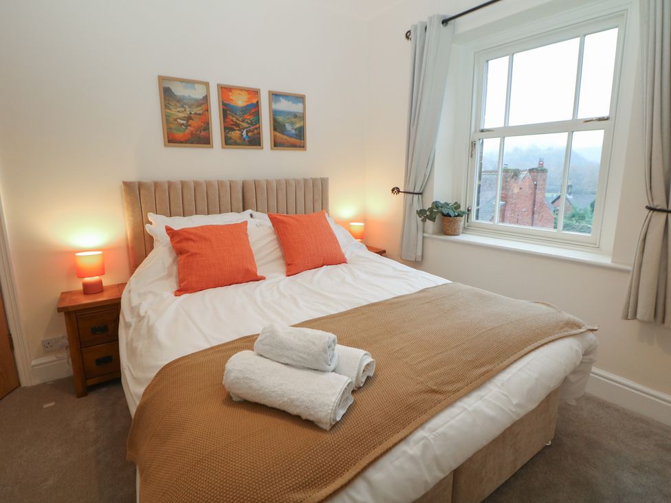 A bedroom with a bed and artwork at Dorset Villas in Matlock