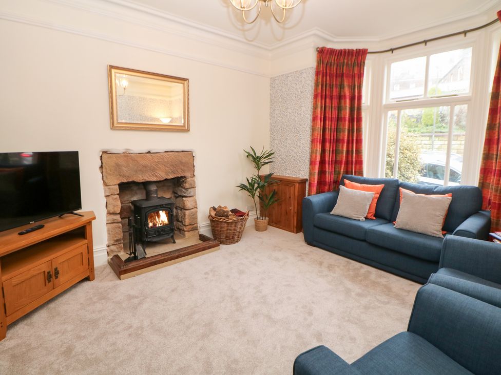 A living room with a television and fireplace at Dorset Villas in Matlock
