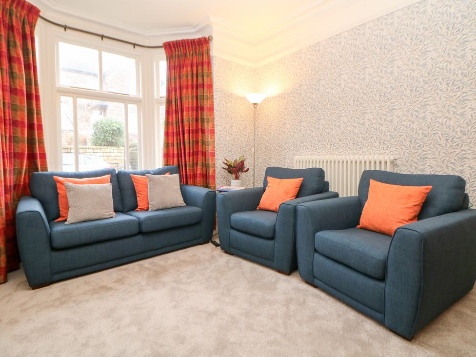 A living room with a sofa and armchairs at Dorset Villas in Matlock