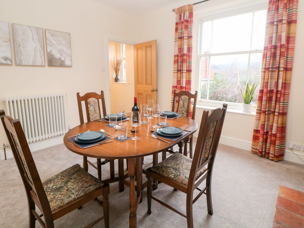 A dining room with a table and chairs at Dorset Villas in Matlock