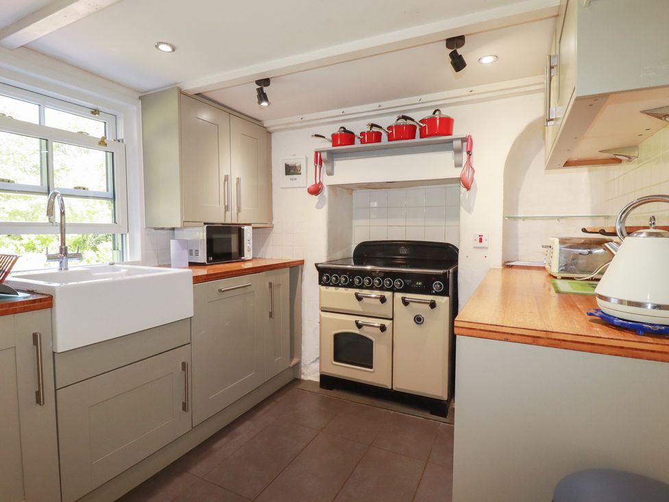 A kitchen with a sink and cooker at Blowing House Cottage near Perranporth