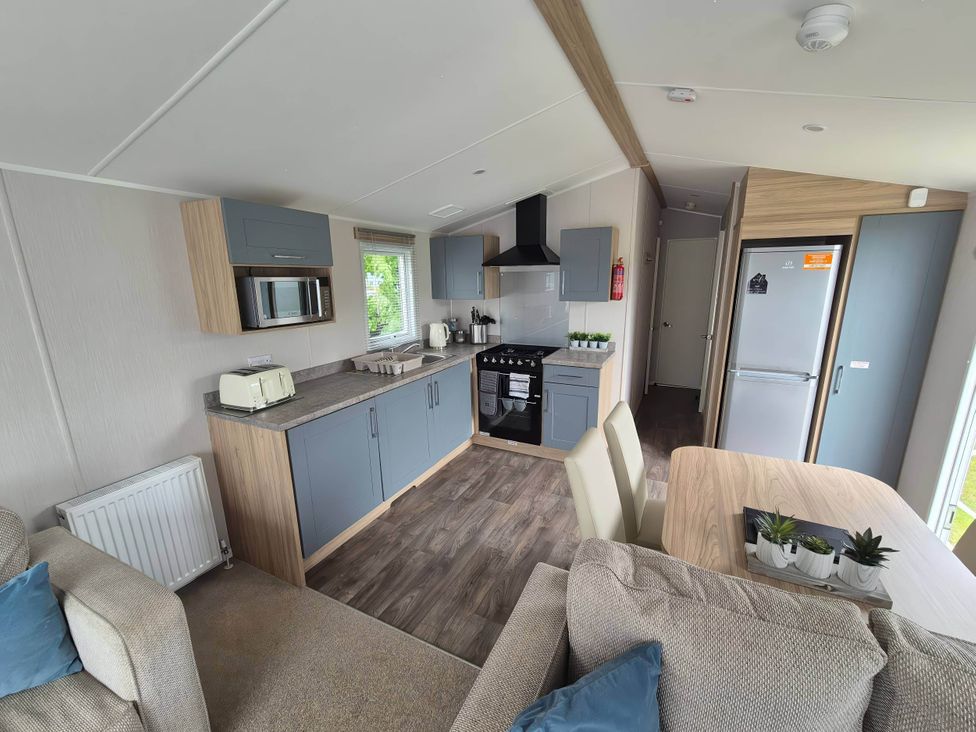 A kitchen with appliances and seating area at 