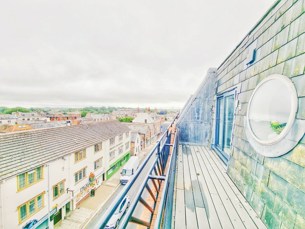 A balcony overlooking a city street at a property