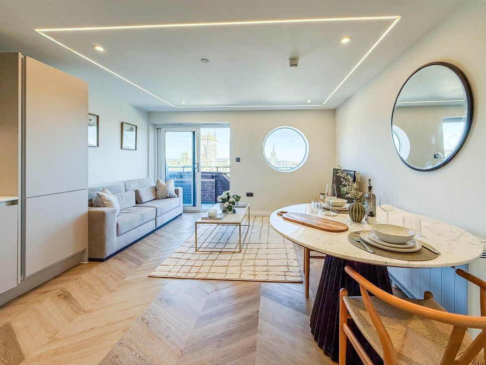 A living room with a couch and dining table at 