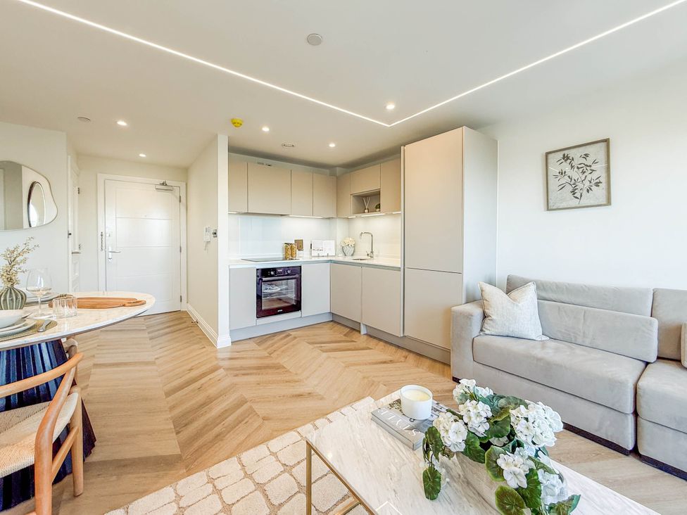 A living room with kitchen area and dining setup at the property