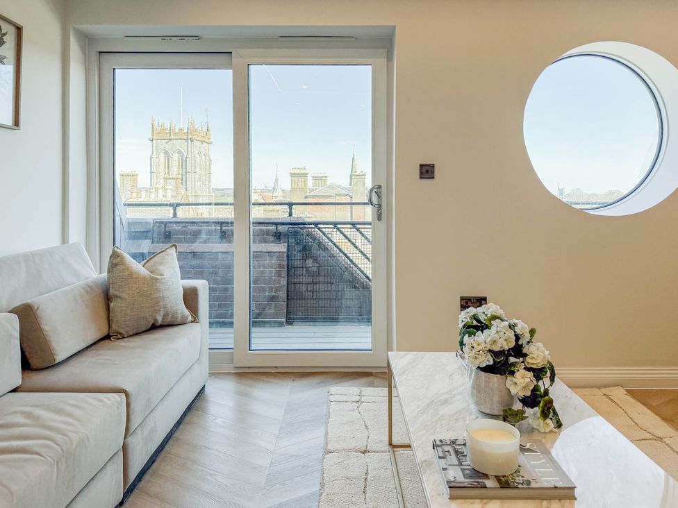 A living room with a sofa and sliding door at 