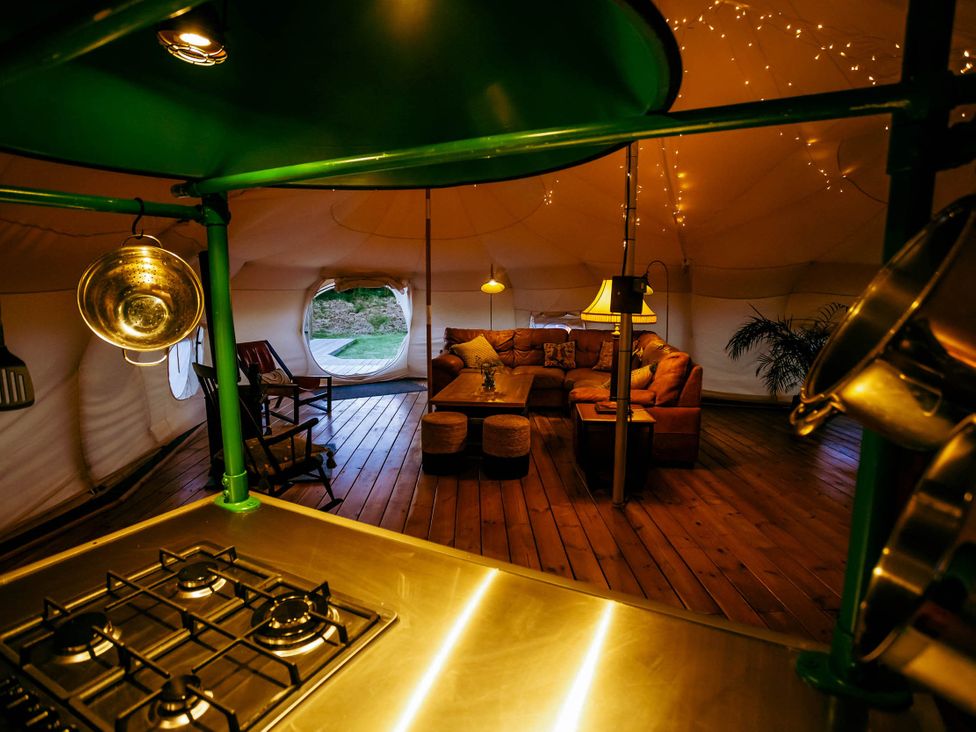 A living room with a sofa and coffee table in a tent at 