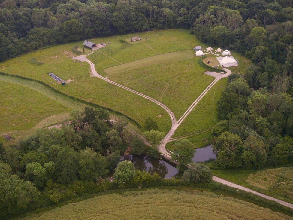 A field with tents and a road at an outdoor location