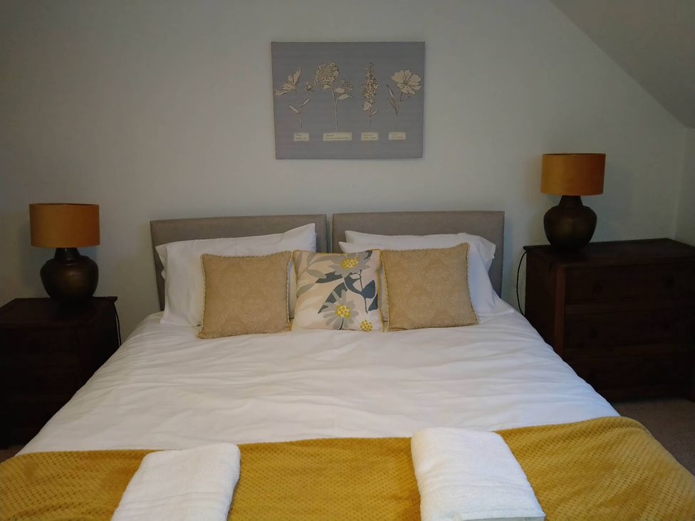 A bedroom with a bed and lamps at The Old Barn in Manchester