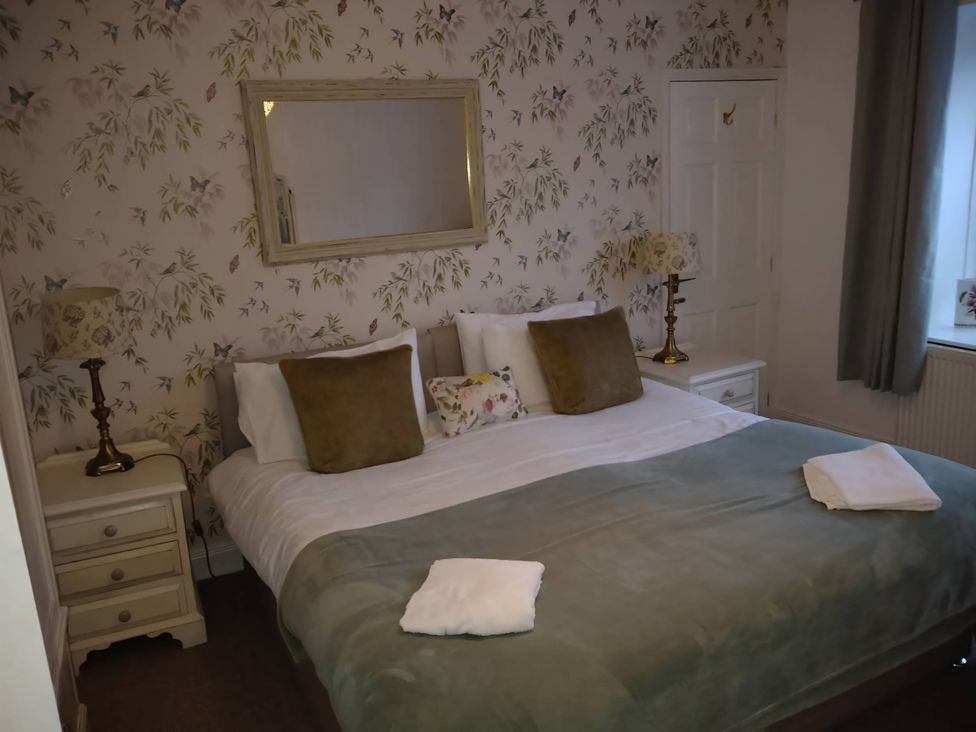 A bedroom with a bed and lamp at The Old Barn in Manchester