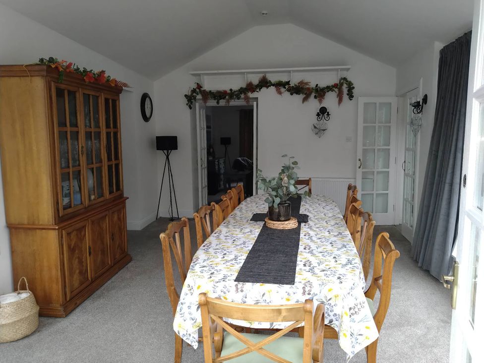 A dining room with a table and chairs at an unspecified location