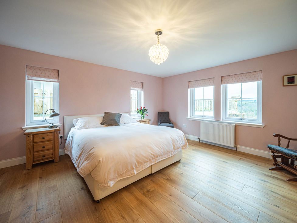 A bedroom with a bed and side table at a property