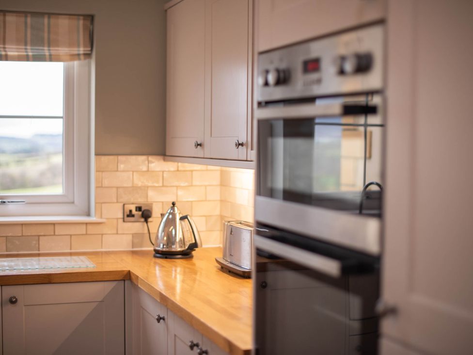 A kitchen with a kettle and toaster on the countertop at The Old Barn in Manchester