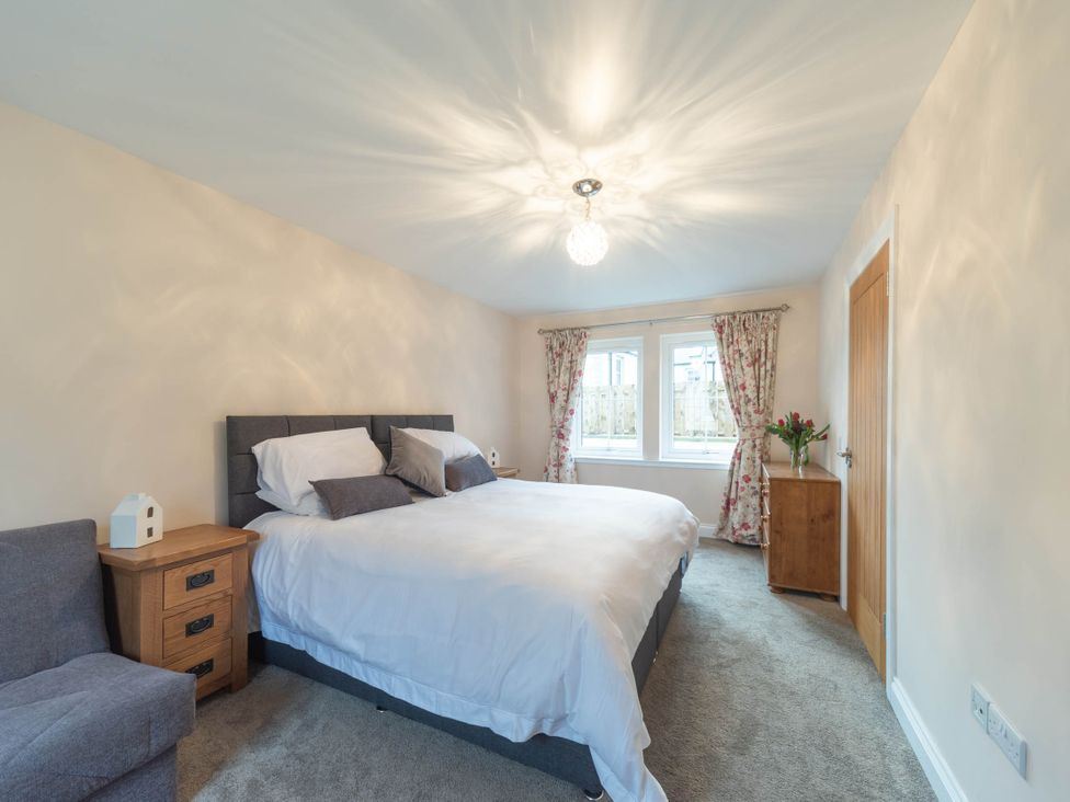 A bedroom with a bed and nightstand at The Old Barn in Manchester