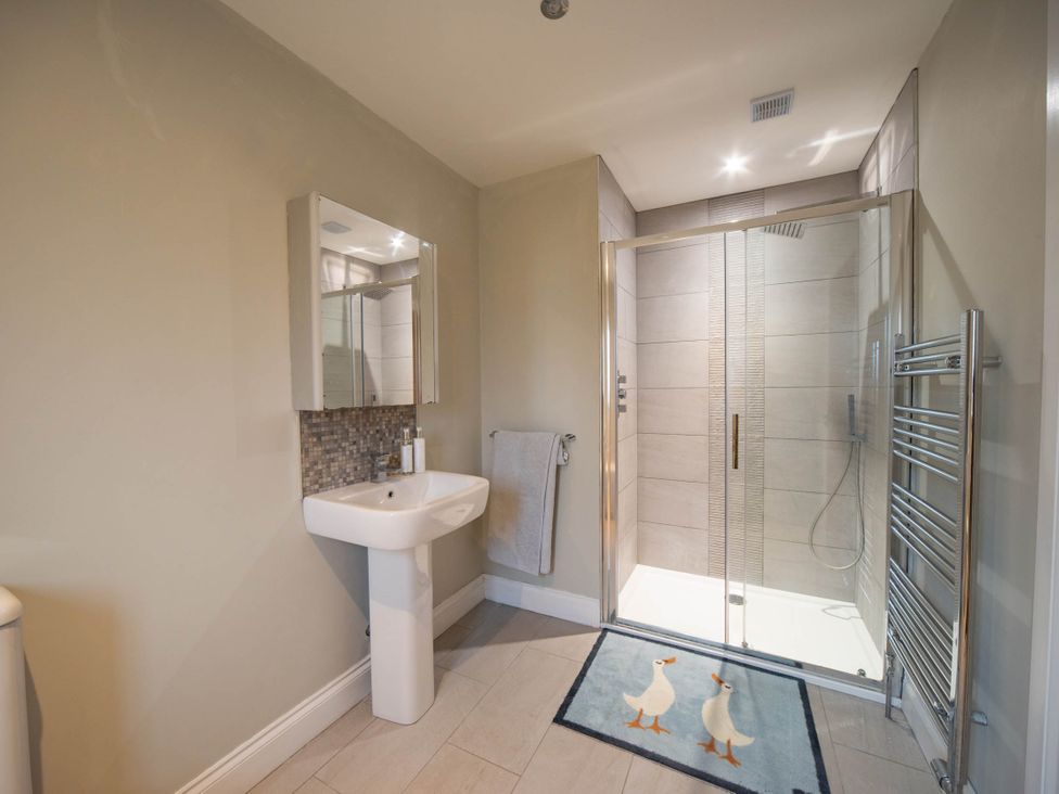A bathroom with a shower and sink at The Old Barn in Manchester