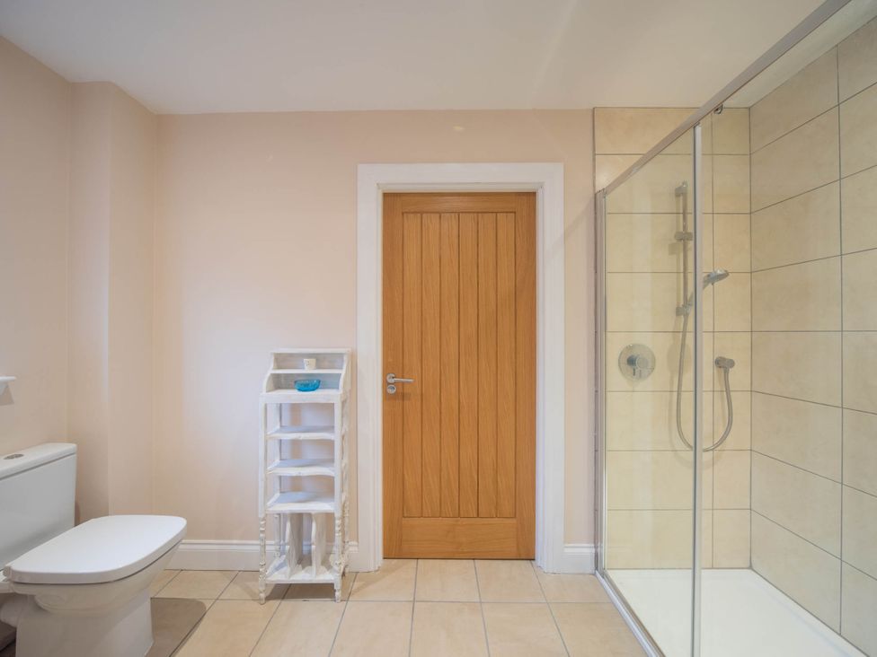 A bathroom with a shower and a toilet at The Old Barn in Manchester