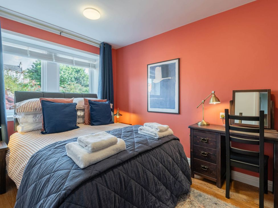 A bedroom with a bed and desk seating area at The Old Barn in Manchester