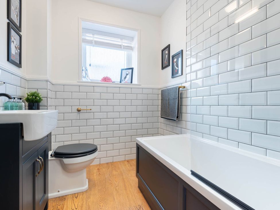 A bathroom with a sink, toilet, and bathtub at The Old Barn in Manchester