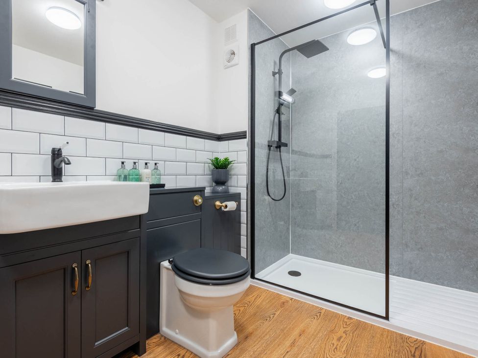 A bathroom featuring a shower, sink, and toilet at the property