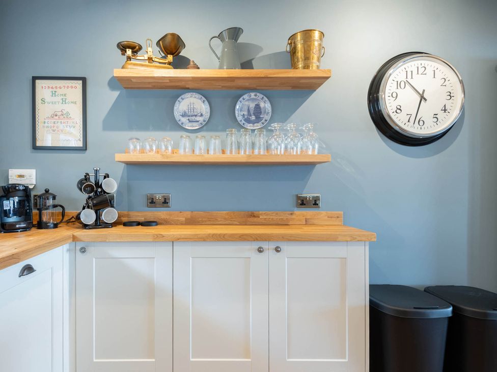 A kitchen with shelves and appliances at the property