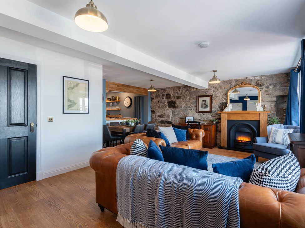 A living room with a fireplace and sofa at the property in the location