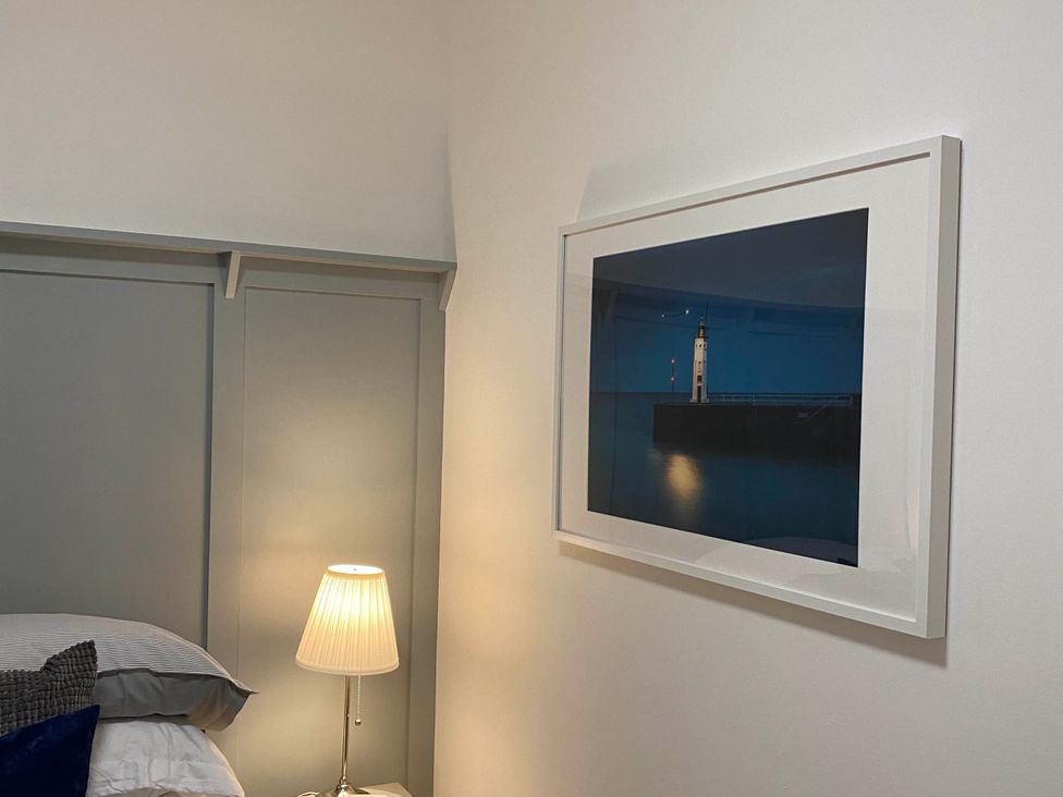 A bedroom with a bed and lamp at the property