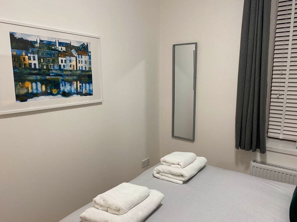 A bedroom with towels on the bed at The Old Barn in Manchester