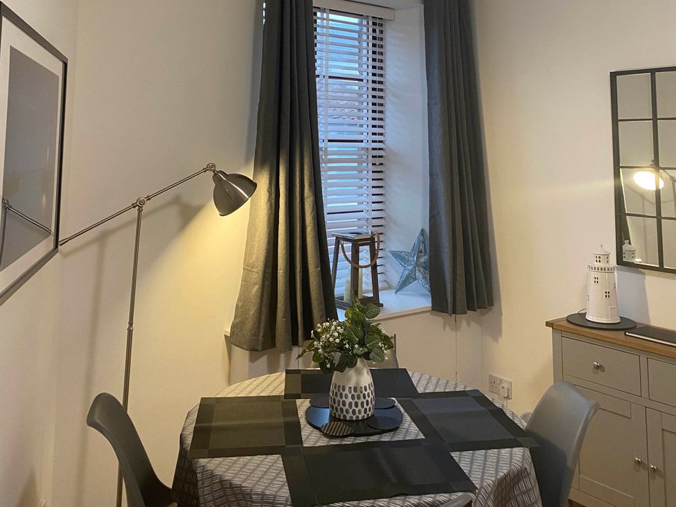 A dining room with a table and chairs at The Old Barn in Manchester