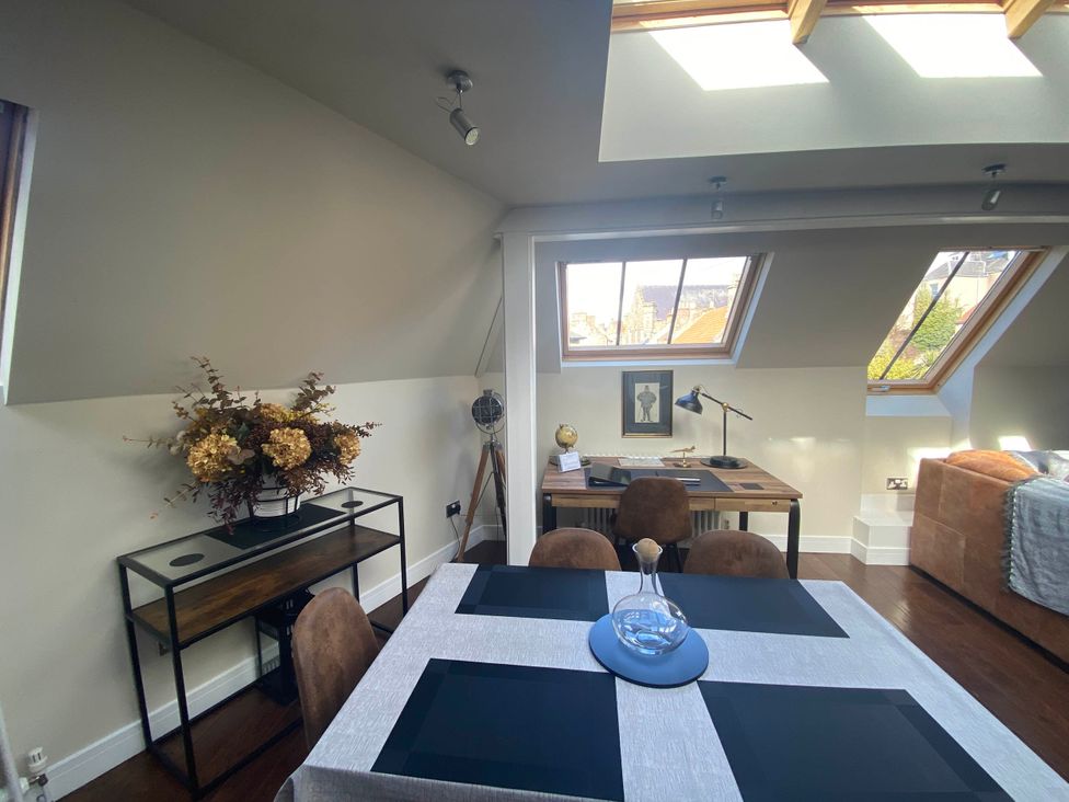 A dining room with a table and chairs and a desk at The Old Barn in Manchester